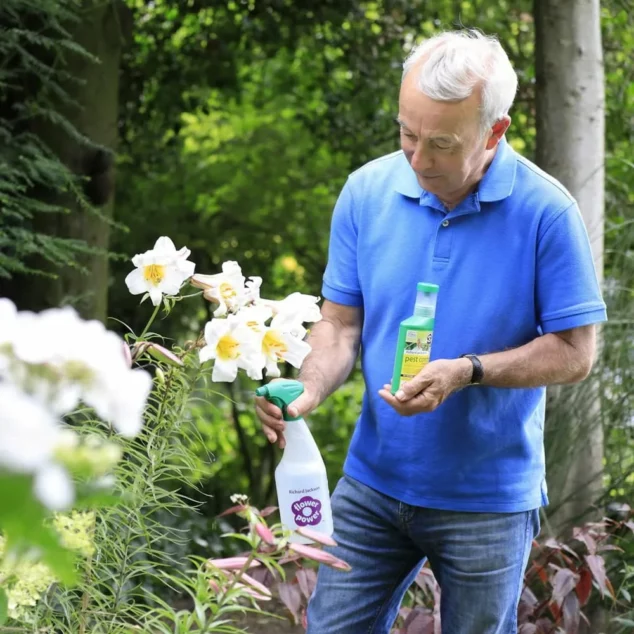 Richard spraying Pest Control on lilies