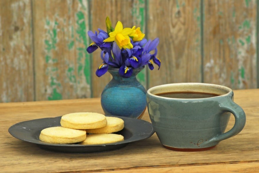 Coffee, biscuits and flowers on a table