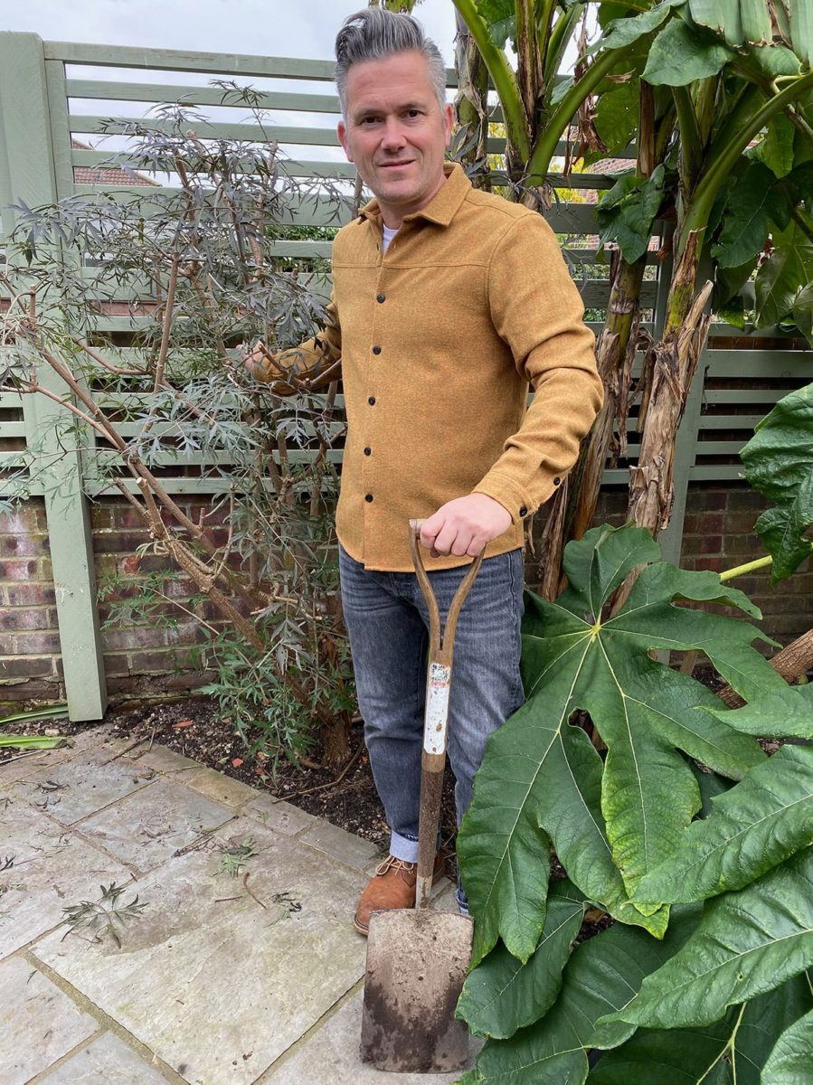 Martyn Cox in garden with cut leaf black elder and Japanese banana