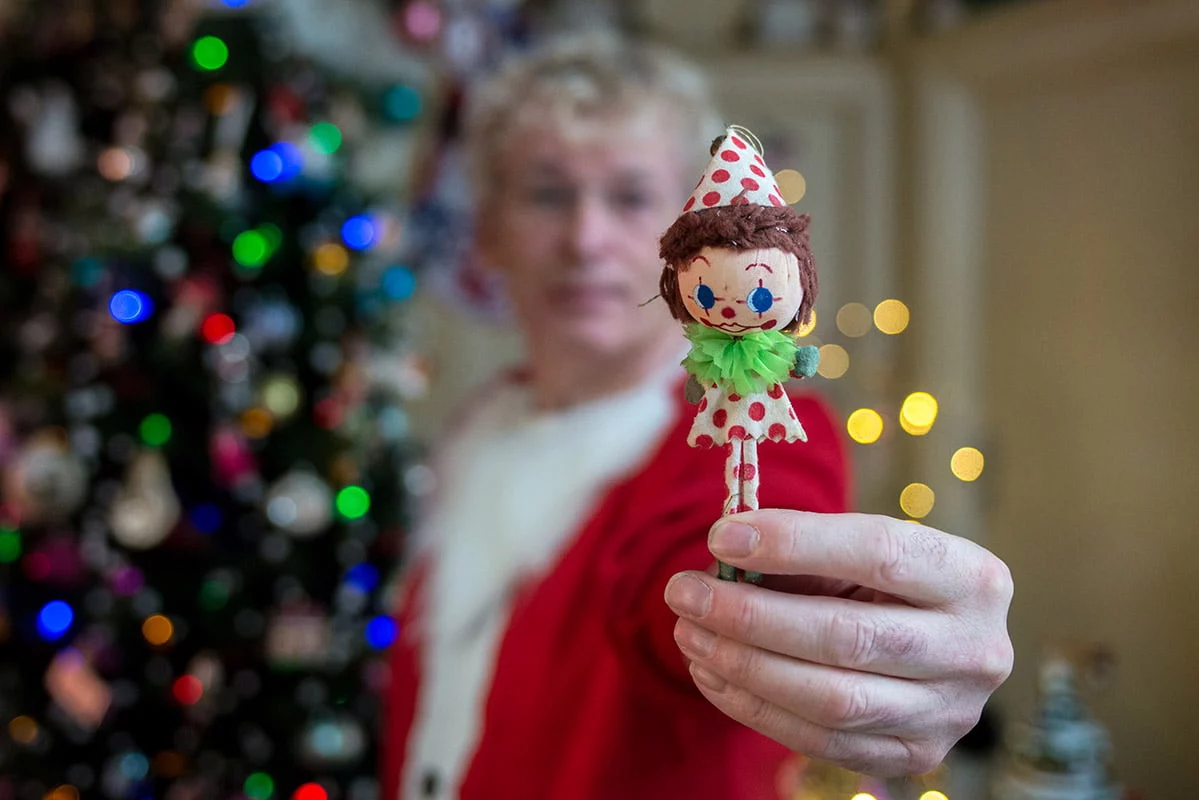 Geoff Stonebanks holding Christmas decoration made by his grandmother