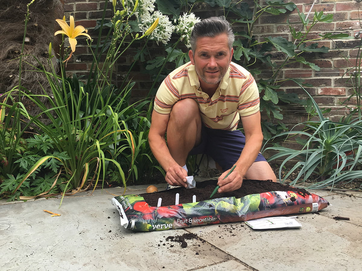 Martyn Cox sowing seeds in grow bag