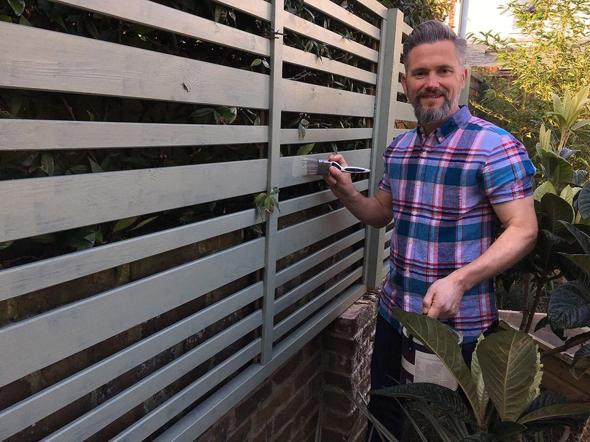 Martyn Cox painting garden fence