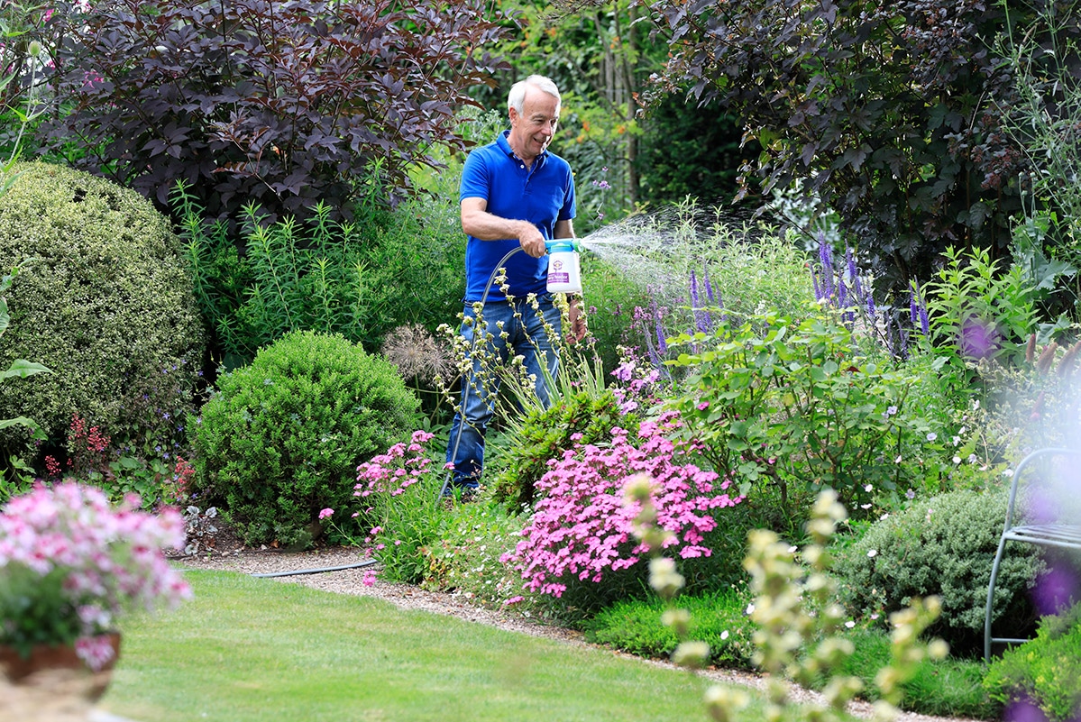 Richard using easy feeder to feed plants with flower power
