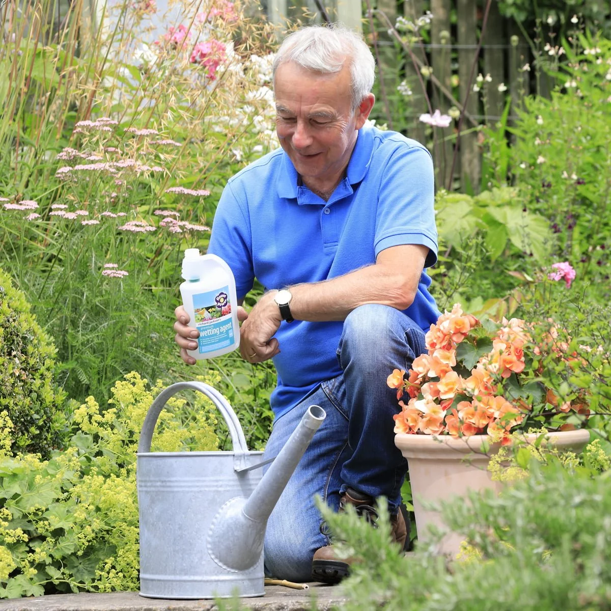 Richard adding wetting agent to watering can