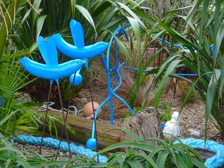 Blue birds and fence at Driftwood garden