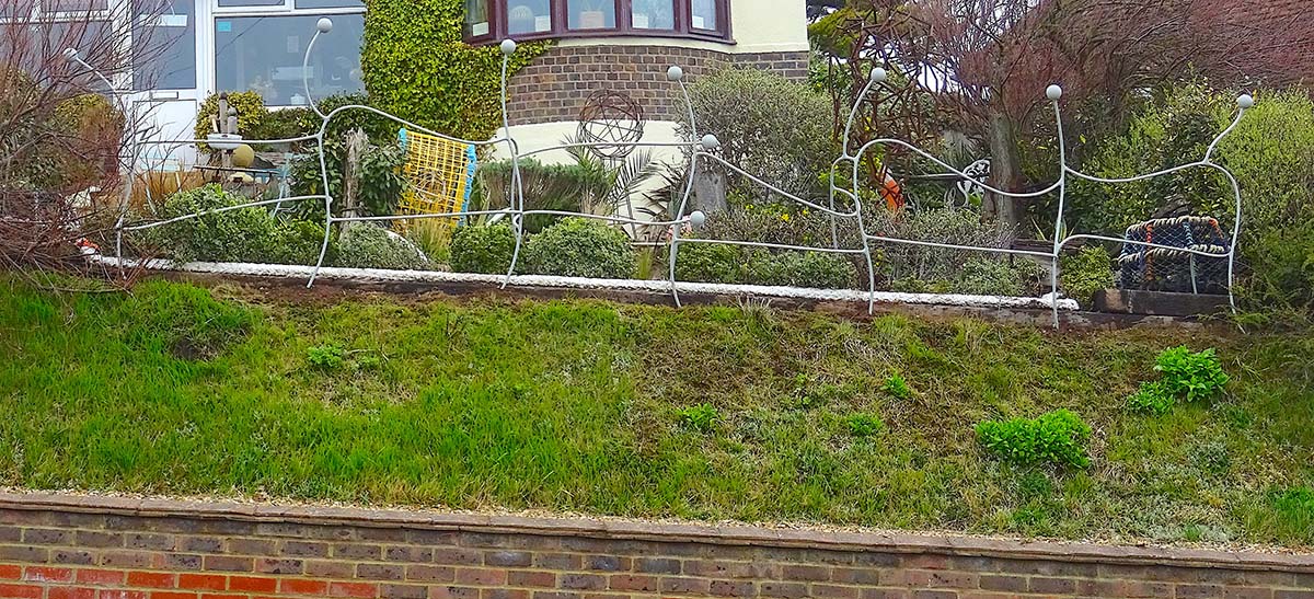 metal fence at front of Driftwood garden