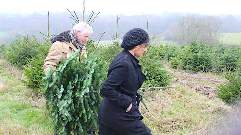 Geoff Stonebanks with Simone Thorogood cutting tree for Christmas