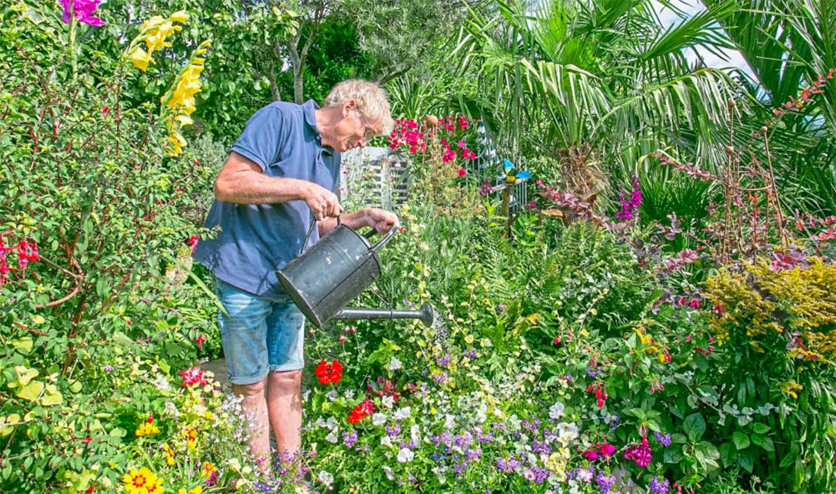 Geoff Stonebanks watering the garden at Driftwood