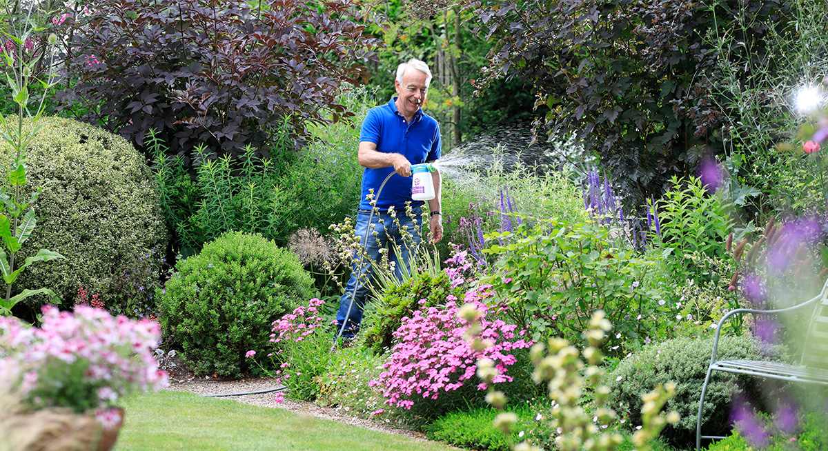 Richard feeding plants using hose end sprayer