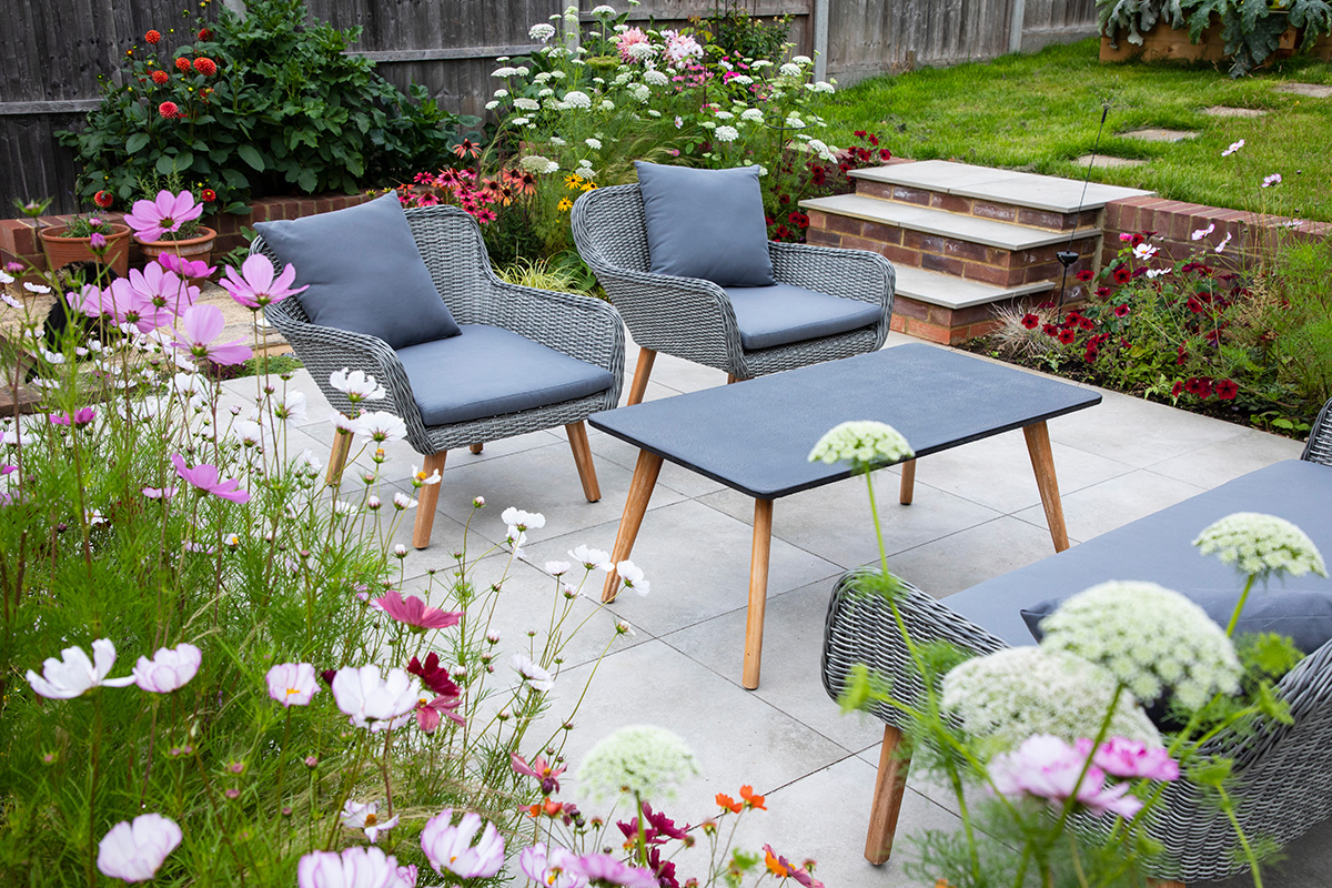 Flowers growing around edge of seating area