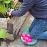Richard using garden kneeler on patio