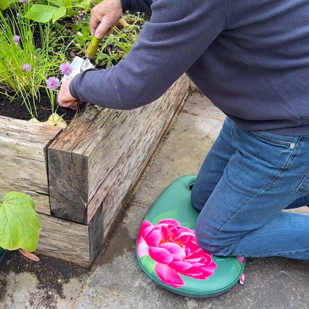 Richard using garden kneeler on patio