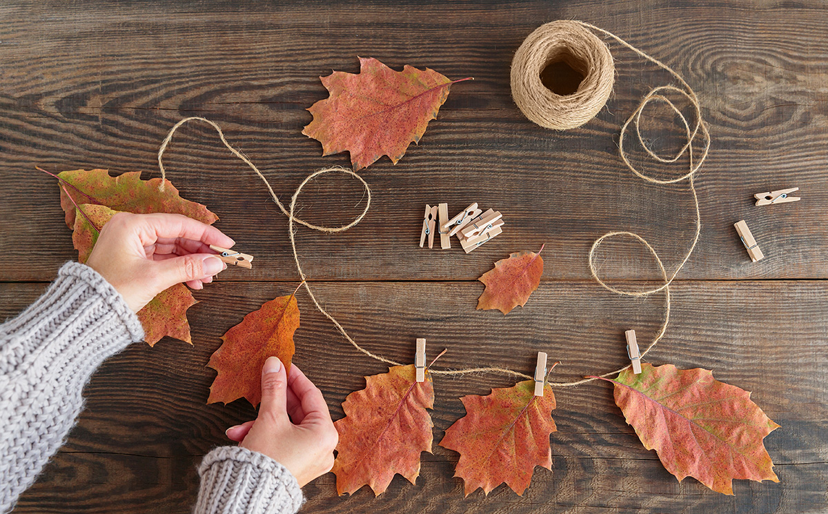 woman creating a leaf garland
